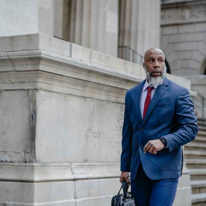 confident black man manager walking on street